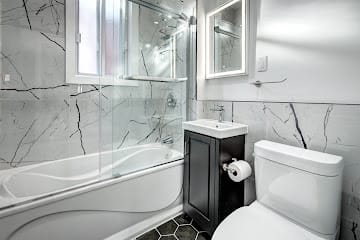 Luxury bathroom with glass vanity by Naybur Contracting