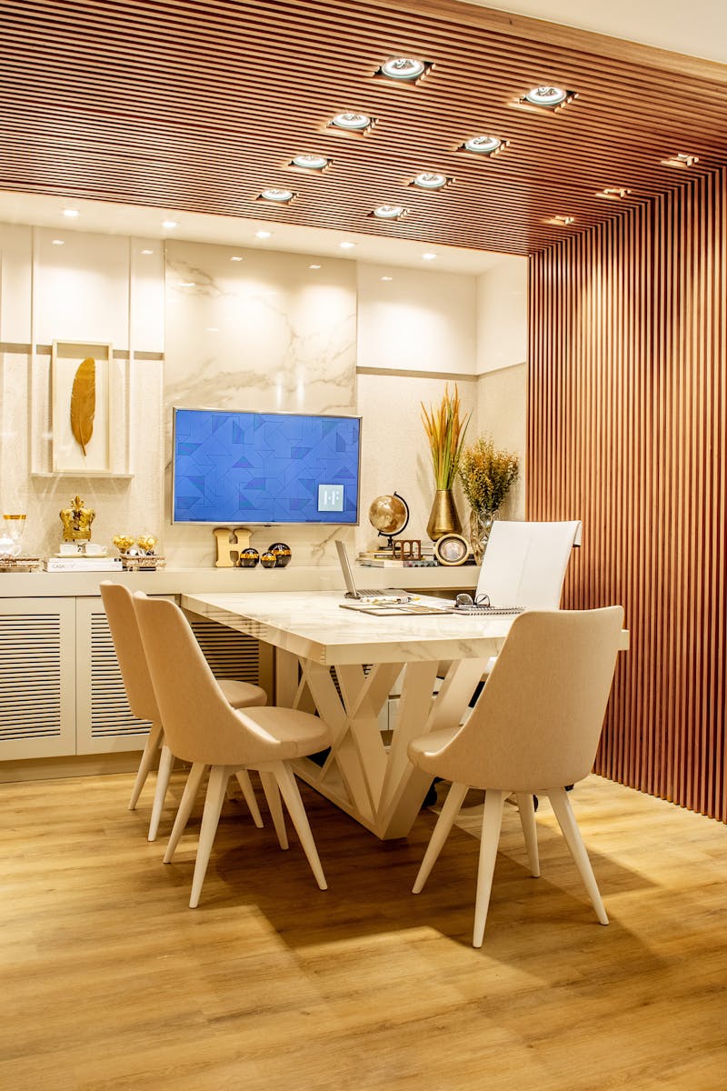 Modern dining room with elegant decor, featuring a stylish table and chairs set, cozy lighting, and artwork.