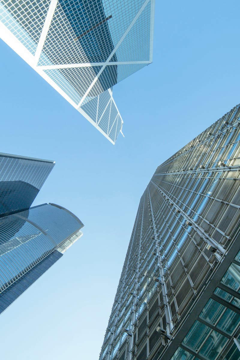 Modern skyscrapers captured from below, showcasing Hong Kong's urban architecture.